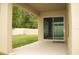 Covered patio overlooking fenced yard through sliding glass doors at 356 Se 66Th Ct, Ocala, FL 34472