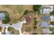Aerial view of a two-story home featuring a circular driveway and landscaped yard in a quiet neighborhood at 4620 Sw 42Nd St, Ocala, FL 34474