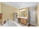 Bathroom featuring a soaking tub, vanity with sink, and a linen closet at 4620 Sw 42Nd St, Ocala, FL 34474