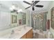 Bathroom featuring double sinks, a shower and tub combo with a floral shower curtain at 4620 Sw 42Nd St, Ocala, FL 34474
