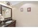 Stylish bathroom with a dark wood vanity, granite countertop, and decorative light fixture at 4620 Sw 42Nd St, Ocala, FL 34474