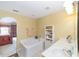 Bathroom featuring a soaking tub, vanity with sink, and tile flooring at 4620 Sw 42Nd St, Ocala, FL 34474