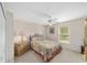 Bright bedroom with carpet, ceiling fan, and a window with a view of the outdoors at 4620 Sw 42Nd St, Ocala, FL 34474