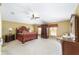 Large primary bedroom featuring carpet flooring, ceiling fan, and plenty of furniture at 4620 Sw 42Nd St, Ocala, FL 34474