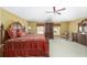 Comfortable primary bedroom featuring carpet flooring, a ceiling fan, and yellow walls at 4620 Sw 42Nd St, Ocala, FL 34474