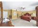 Spacious primary bedroom featuring yellow walls, carpet flooring, and a walk-in closet at 4620 Sw 42Nd St, Ocala, FL 34474