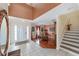 Open entryway with tile flooring, a staircase, and hardwood flooring at 4620 Sw 42Nd St, Ocala, FL 34474