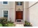 Inviting front door with decorative details, sidelights, and a tiled walkway at 4620 Sw 42Nd St, Ocala, FL 34474