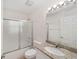 Bathroom featuring granite counters, shower/tub combo, and modern lighting at 4886 Nw 30Th Pl, Ocala, FL 34482
