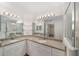 Bright bathroom features double sinks, granite countertops, ample cabinetry and a glass enclosed shower at 4886 Nw 30Th Pl, Ocala, FL 34482