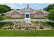 Community clubhouse featuring lush landscaping and a charming facade at 4886 Nw 30Th Pl, Ocala, FL 34482