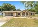 Charming single-story home featuring a well-maintained lawn, screened garage and an inviting entrance at 4886 Nw 30Th Pl, Ocala, FL 34482