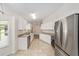 Bright kitchen features stainless steel appliances, granite countertops, ample cabinetry, and tile flooring at 4886 Nw 30Th Pl, Ocala, FL 34482