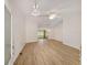 Bright, open-concept living room featuring modern light fixtures and beautiful wood-look flooring at 4886 Nw 30Th Pl, Ocala, FL 34482