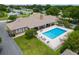 Aerial view of a community clubhouse with a pool, patio, and lawn area at 4886 Nw 30Th Pl, Ocala, FL 34482