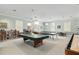 Spacious recreation room featuring a pool table, ping pong table, and ample seating at 4886 Nw 30Th Pl, Ocala, FL 34482