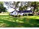 Back view of well-maintained home with manicured lawn and manicured landscaping at 5351 Sw 80Th Pl, Ocala, FL 34476
