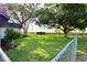 Large, grassy backyard featuring a fence and mature trees creating a private outdoor space at 5351 Sw 80Th Pl, Ocala, FL 34476