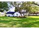 Back of home overlooking manicured lawn and established landscaping at 5351 Sw 80Th Pl, Ocala, FL 34476