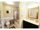 Bathroom with tiled shower, white vanity, framed mirror and coordinating fixtures at 5351 Sw 80Th Pl, Ocala, FL 34476