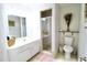 Bathroom featuring shower stall, white vanity, neutral tile, and stylish fixtures at 5351 Sw 80Th Pl, Ocala, FL 34476