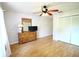 Bright bedroom features wood floors, ceiling fan, and closet with louvered doors at 5351 Sw 80Th Pl, Ocala, FL 34476