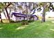 Brick home with a lush front yard and mature trees creating a tranquil setting at 5351 Sw 80Th Pl, Ocala, FL 34476