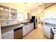 Bright, open kitchen featuring white cabinets, stainless steel appliances, and tile flooring throughout at 5351 Sw 80Th Pl, Ocala, FL 34476