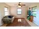 Sun-lit living room features a large window, comfortable seating, and modern decor at 5351 Sw 80Th Pl, Ocala, FL 34476