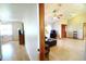 Open-concept living room features hardwood floors, lots of light, and views of the entry and adjoining room at 5351 Sw 80Th Pl, Ocala, FL 34476