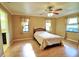 Bedroom with laminate floors, neutral walls, windows with curtain panels, and ceiling fan at 5351 Sw 80Th Pl, Ocala, FL 34476