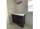 Bathroom with dark vanity, white countertop, and modern lighting at 5359 Nw 55Th Pl, Ocala, FL 34482