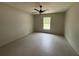 This bedroom has lots of natural light from a large window, tile floors, and a ceiling fan at 5359 Nw 55Th Pl, Ocala, FL 34482