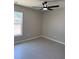 Bedroom showing window with view, modern ceiling fan, and neutral paint at 5359 Nw 55Th Pl, Ocala, FL 34482