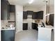 Kitchen with dark cabinets, white countertops and ceramic tile at 5359 Nw 55Th Pl, Ocala, FL 34482