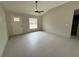 Living room featuring high ceilings, a ceiling fan, and gray tile floors at 5359 Nw 55Th Pl, Ocala, FL 34482