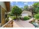 View of the backyard with lush landscaping, mature trees, and detached garage at 5521 Sw 31St St, Ocala, FL 34474
