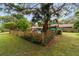 Fenced backyard with mature trees, green lawn and swimming pool view at 5521 Sw 31St St, Ocala, FL 34474