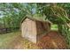 Tan barn with gable roof surrounded by trees and foliage at 5521 Sw 31St St, Ocala, FL 34474