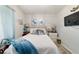Cozy bedroom with light walls, soft bedding, bedside tables and wall decor at 5521 Sw 31St St, Ocala, FL 34474