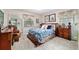 Comfortable bedroom with a large mirror, wooden bed frame, and windows offering natural light at 5521 Sw 31St St, Ocala, FL 34474