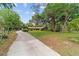 Long driveway leads to a home with mature trees and landscaping at 5521 Sw 31St St, Ocala, FL 34474