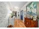 Hallway featuring wood floors, a decorative sideboard, and elegant decor, with a view of the front door at 5521 Sw 31St St, Ocala, FL 34474