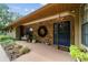 Inviting front porch with stone accents, a stylish light fixture, and a cozy seating area at 5521 Sw 31St St, Ocala, FL 34474
