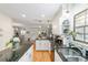 Well-lit kitchen featuring granite countertops, white cabinetry, and modern appliances at 5521 Sw 31St St, Ocala, FL 34474