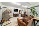 Cozy living area with comfortable seating, a television, and a tropical houseplant at 5521 Sw 31St St, Ocala, FL 34474