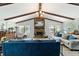 Cozy living room featuring a stone fireplace, exposed beams, and comfortable seating arrangements at 5521 Sw 31St St, Ocala, FL 34474