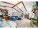 Open living room with vaulted ceilings, wooden beams, and stylish decor with a fireplace at 5521 Sw 31St St, Ocala, FL 34474
