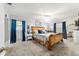 Relaxing main bedroom with bright blue curtains and a king sized bed at 5521 Sw 31St St, Ocala, FL 34474