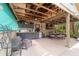Covered outdoor kitchen area with prep sink and mini fridge adjacent to dining area is great for entertaining at 5521 Sw 31St St, Ocala, FL 34474